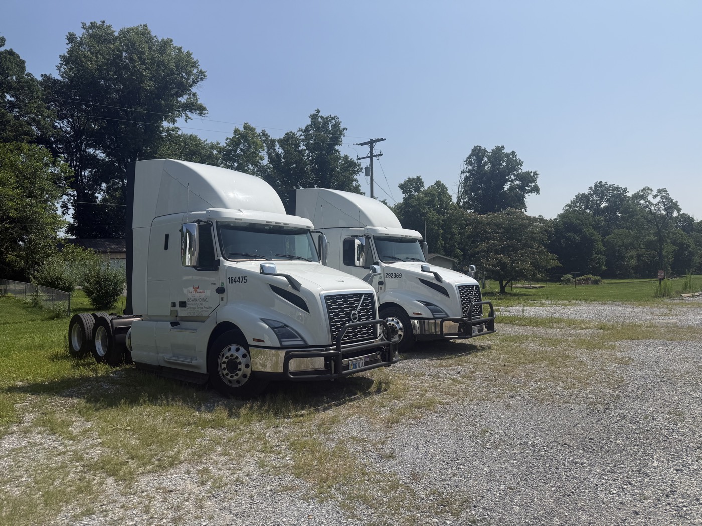 Two J&S Anand Volvo tractors parked outside the shop