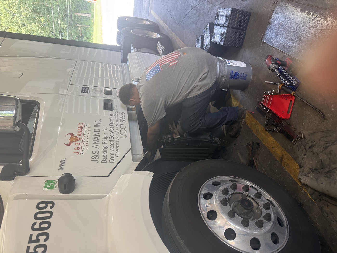 J&S Anand mechanic Donovan servicing a Volvo tractor in the shop bay